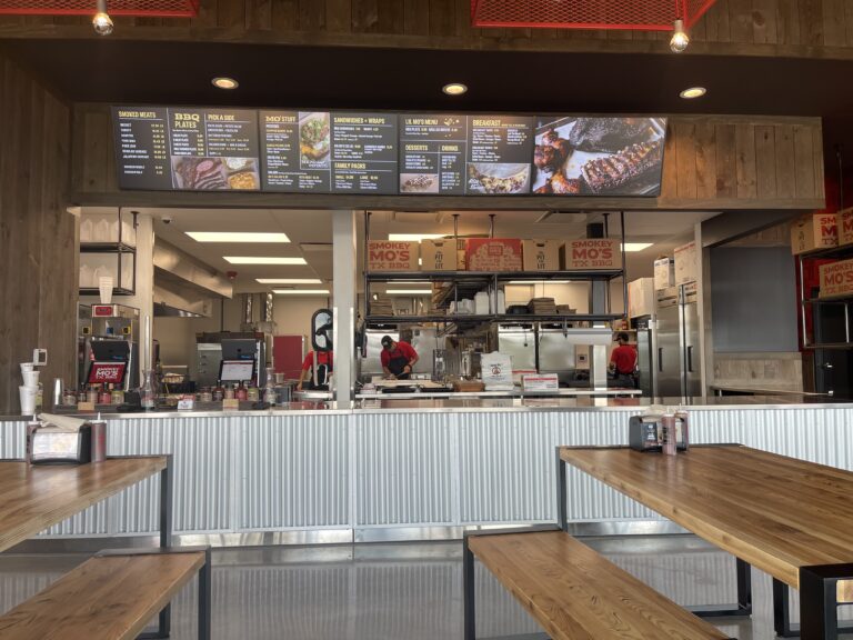 Three horizontal digital menu boards in a restaurant