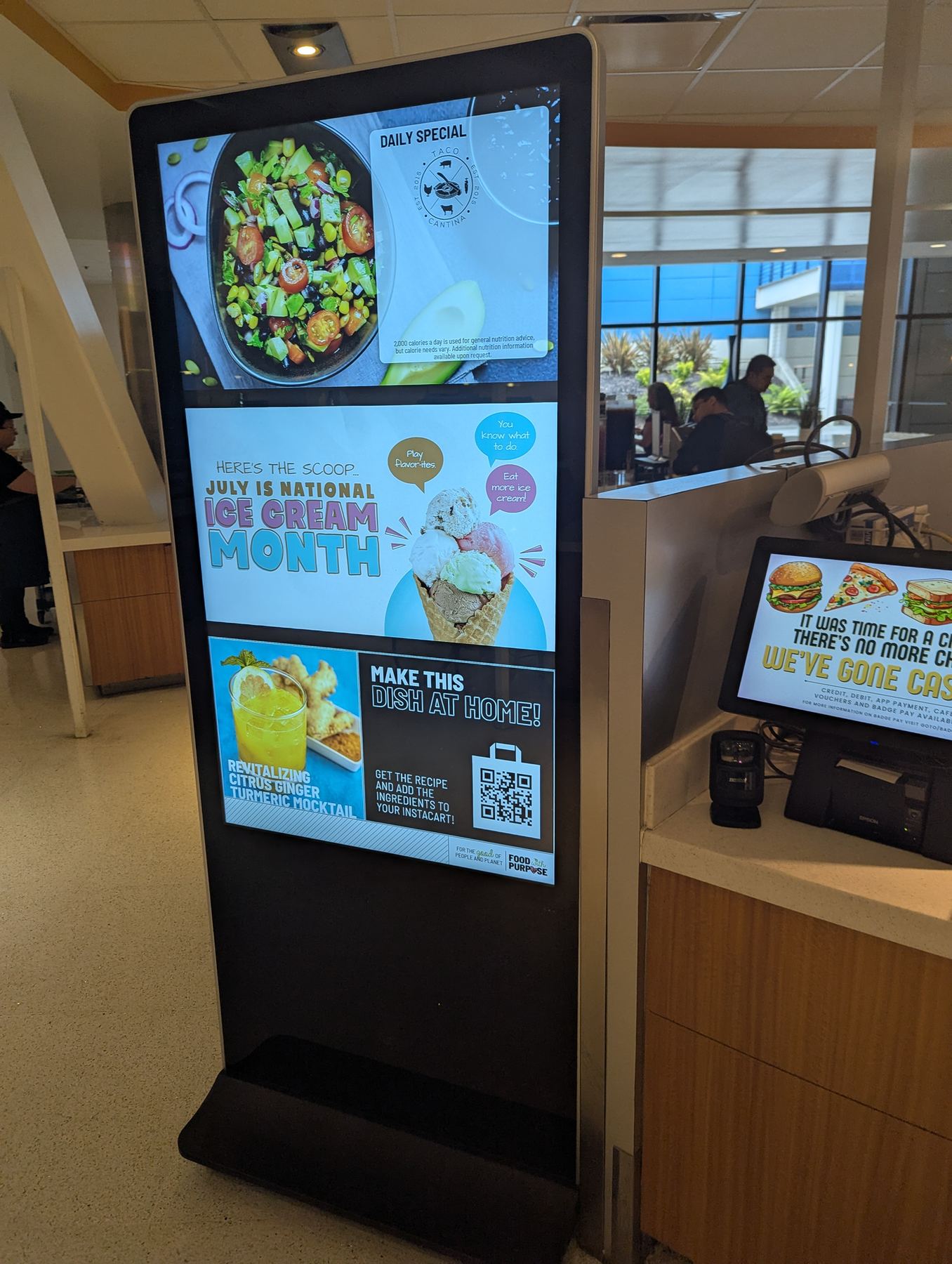 Freestanding WAND digital kiosk showing daily specials and promotions